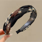 Side view of Gifty fabric woven twist headband showing texture and weave