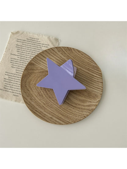 Beau star shaped claw clip in natural light highlighting texture