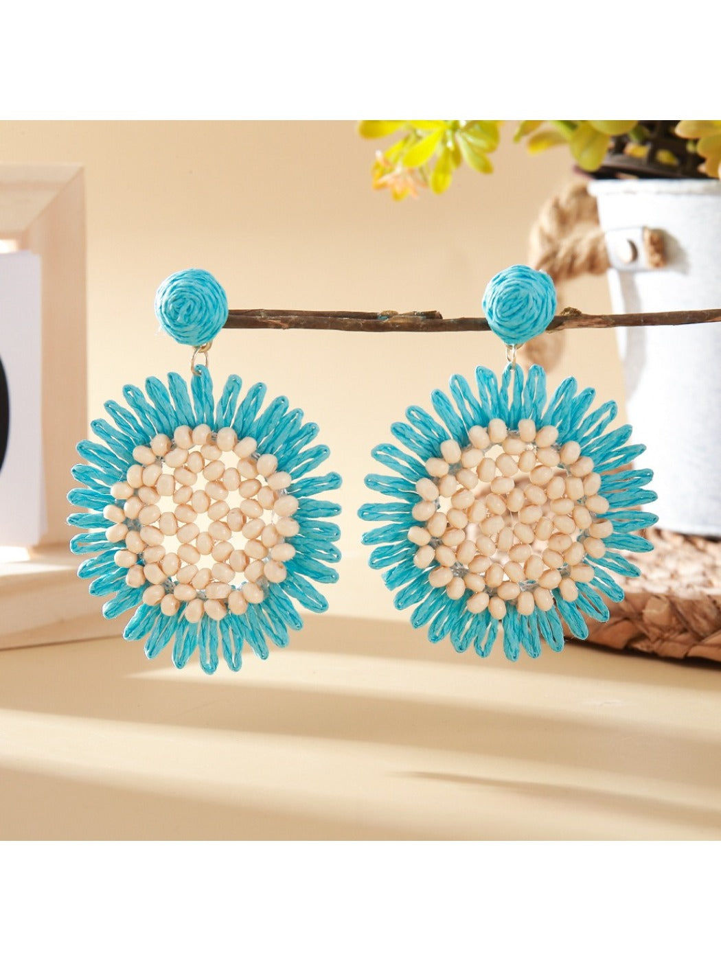 Elegant sunflower shaped drop earrings displayed in a jewelry box