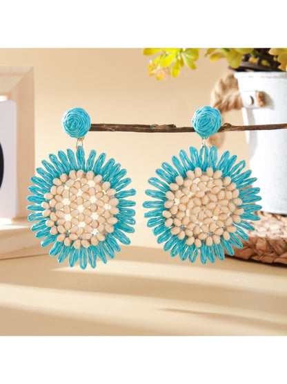 Elegant sunflower shaped drop earrings displayed in a jewelry box