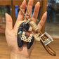 Fabric pony keychain with embroidered features and metal clasp