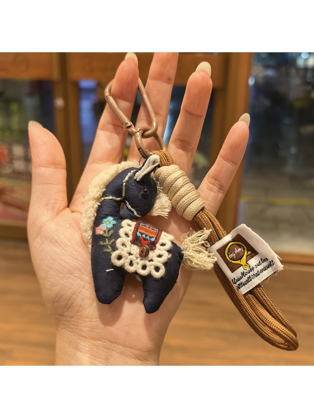 Fabric pony keychain with embroidered features and metal clasp