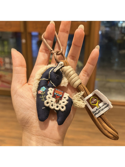 Fabric pony keychain with embroidered features and metal clasp