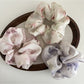 Side view of Gifty fashionable satin scrunchie highlighting fabric texture and pattern