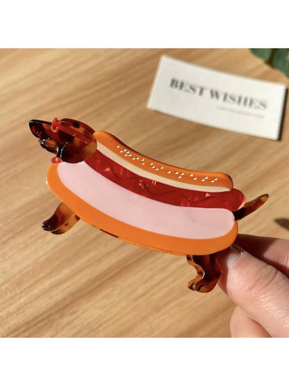 Beau cartoon dachshund claw clip displayed on a flat surface with shadow