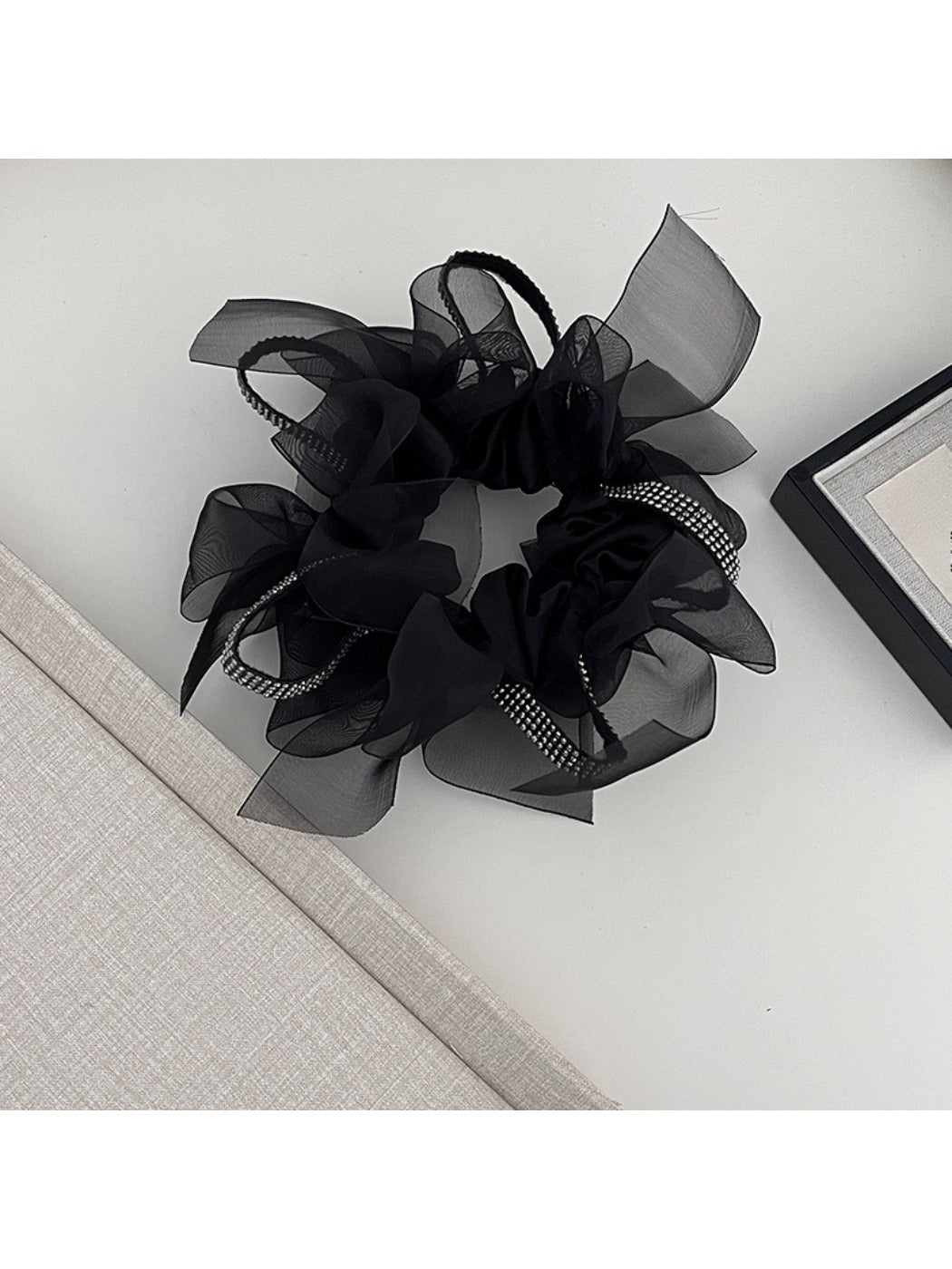 Side view of Gifty dark large bow scrunchie showing fabric texture