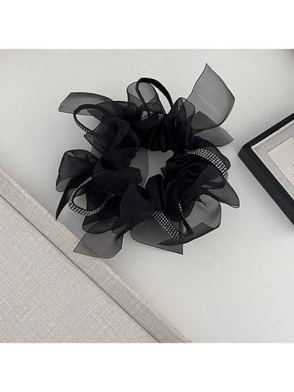 Side view of Gifty dark large bow scrunchie showing fabric texture
