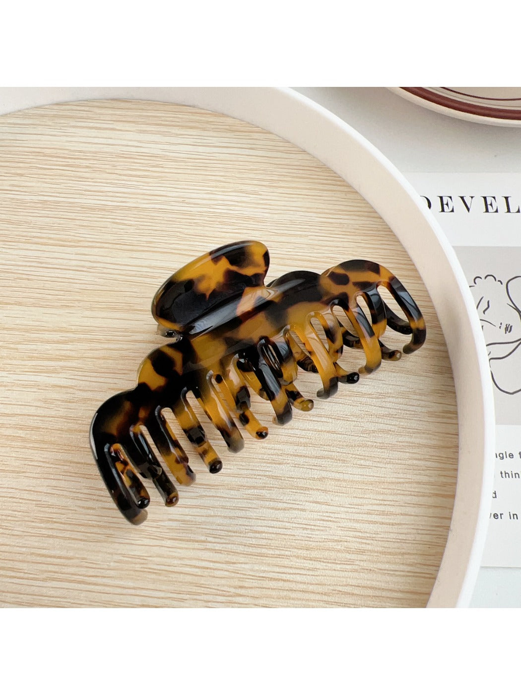 Beau claw clip held in hand showing size and ergonomic design