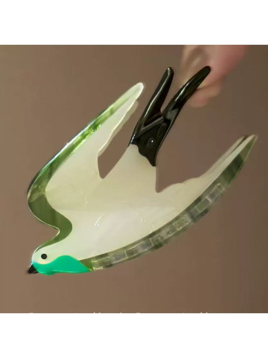 Beau bird shape claw clip styled in hair with soft natural lighting