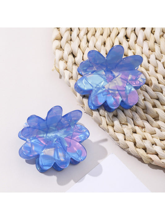 Blue flower shaped hair clip with detailed petals on white background