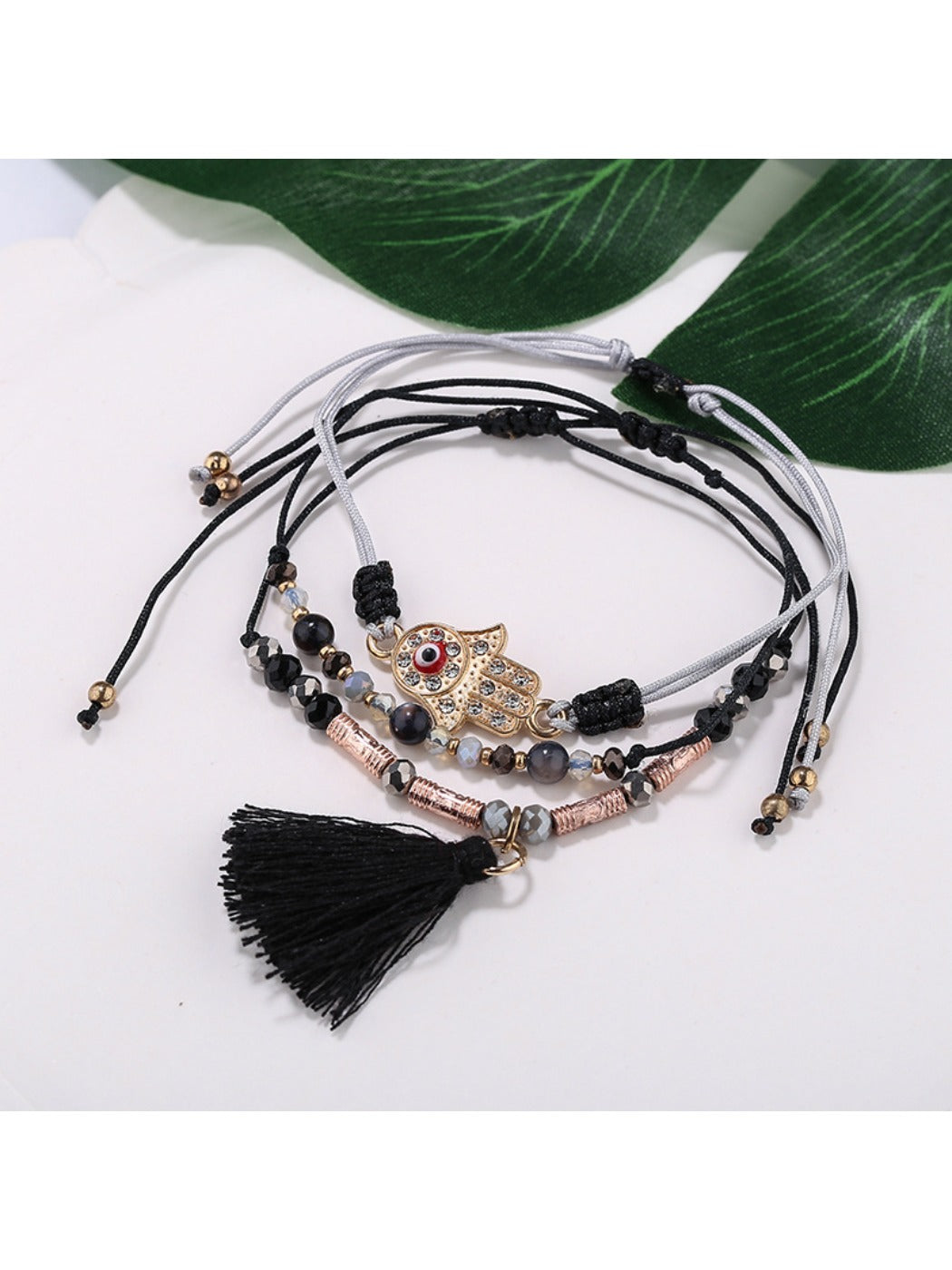 Lovra bracelet with alloy charm and tassel pendant displayed flat