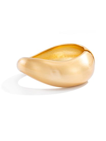 Lovra silver bracelet with unique irregular texture placed on wooden surface