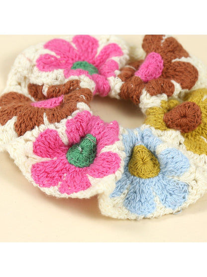 Scrunchie wrapped around a ponytail on a model with long brown hair