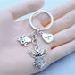 Close-up of alloy angel shaped keychain with detailed wings and halo