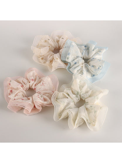 Close-up of Gifty Sweet Graceful Floral Scrunchie with pink and white floral pattern