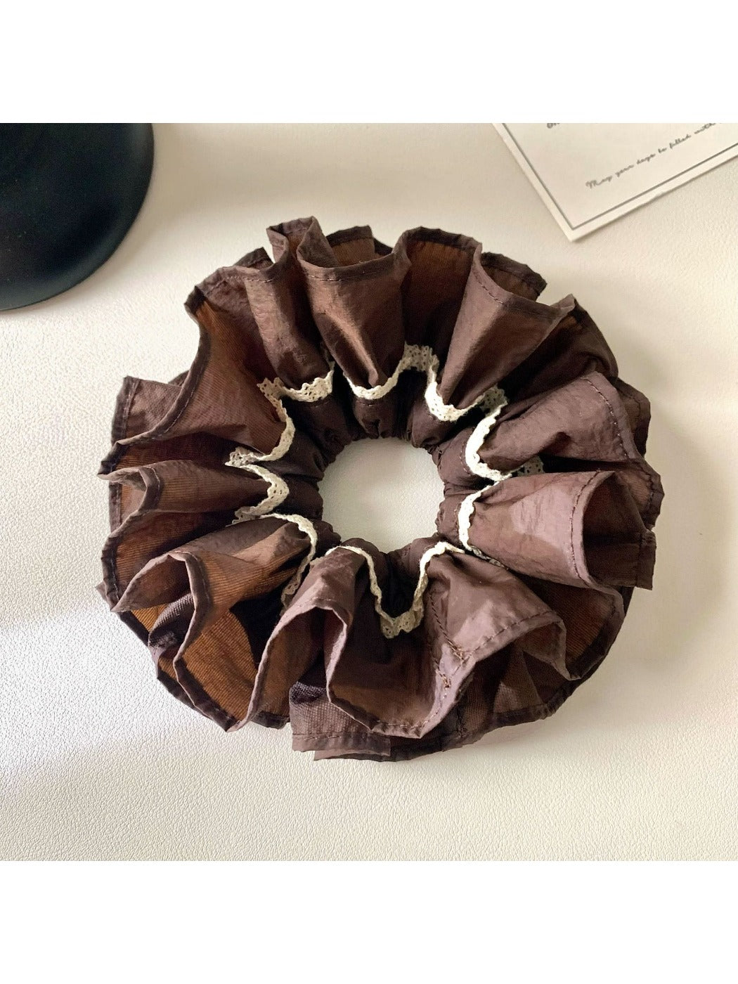 Gifty vintage dark double layered scrunchie displayed on a wooden surface