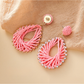 Pair of Bohemian geometric raffia drop earrings with natural fiber texture