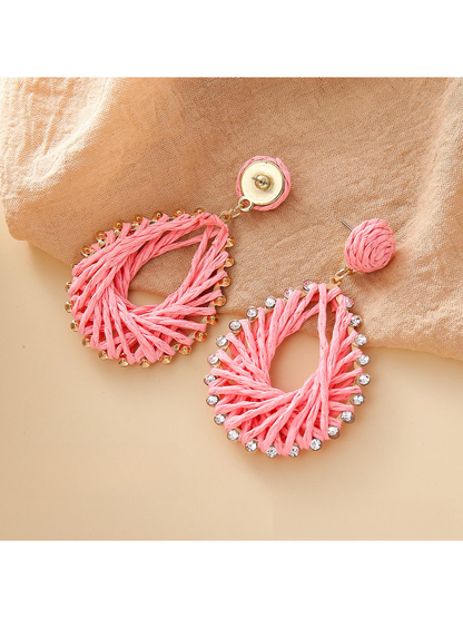 Pair of Bohemian geometric raffia drop earrings with natural fiber texture
