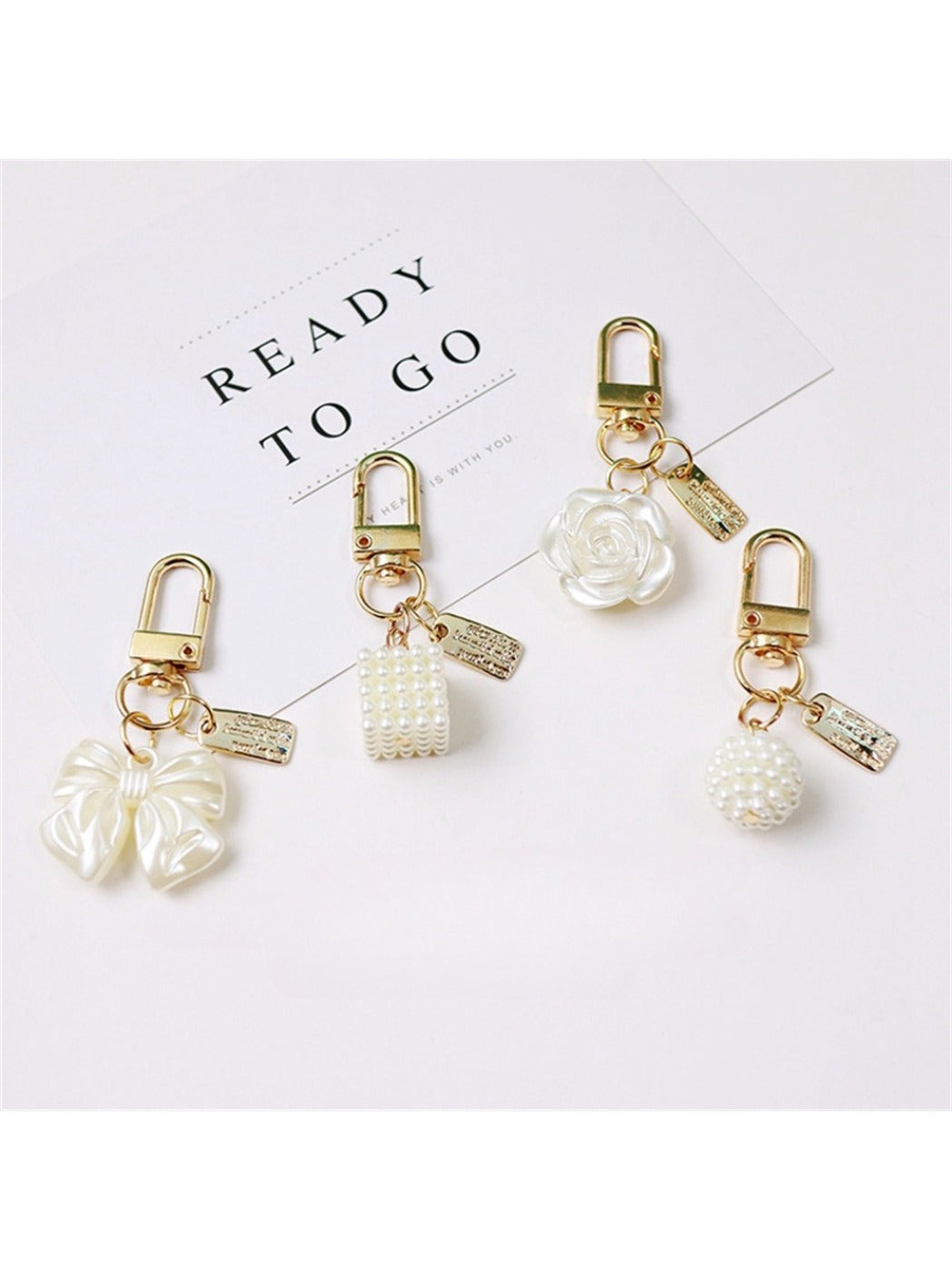Close-up of Keypus trendy beaded bow charm keychain with colorful beads and gold ring