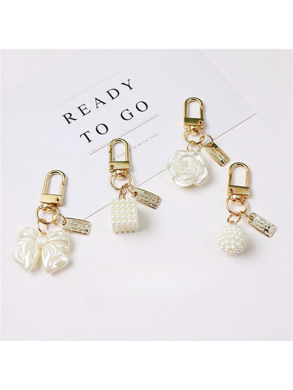 Close-up of Keypus trendy beaded bow charm keychain with colorful beads and gold ring