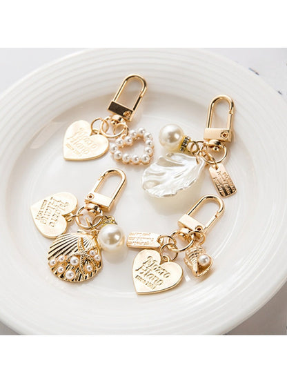 Close-up of a shiny alloy heart keychain with a smooth finish