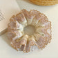 Gifty satin lace trim hair scrunchie displayed on a white background