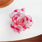 Beau flower-shaped claw clip in use securing thick hair from the back