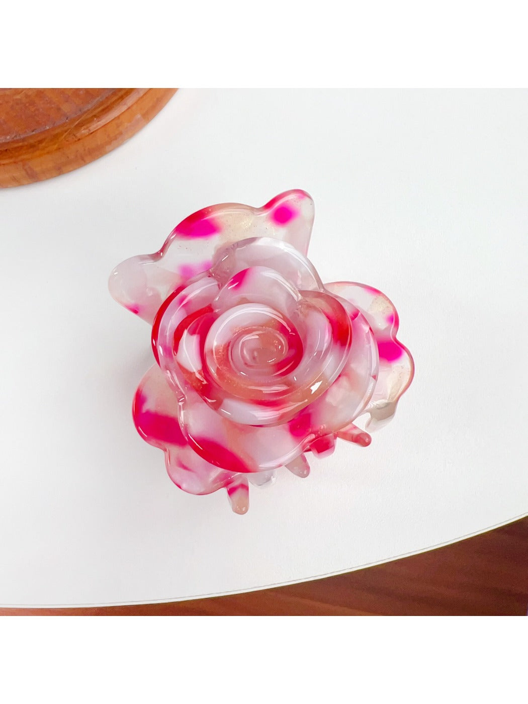 Beau flower-shaped claw clip in use securing thick hair from the back