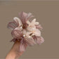 Sweet pink bow scrunchie made of soft fabric, styled on a white background