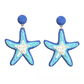 Starfish shaped raffia woven stud earrings shown from the side angle