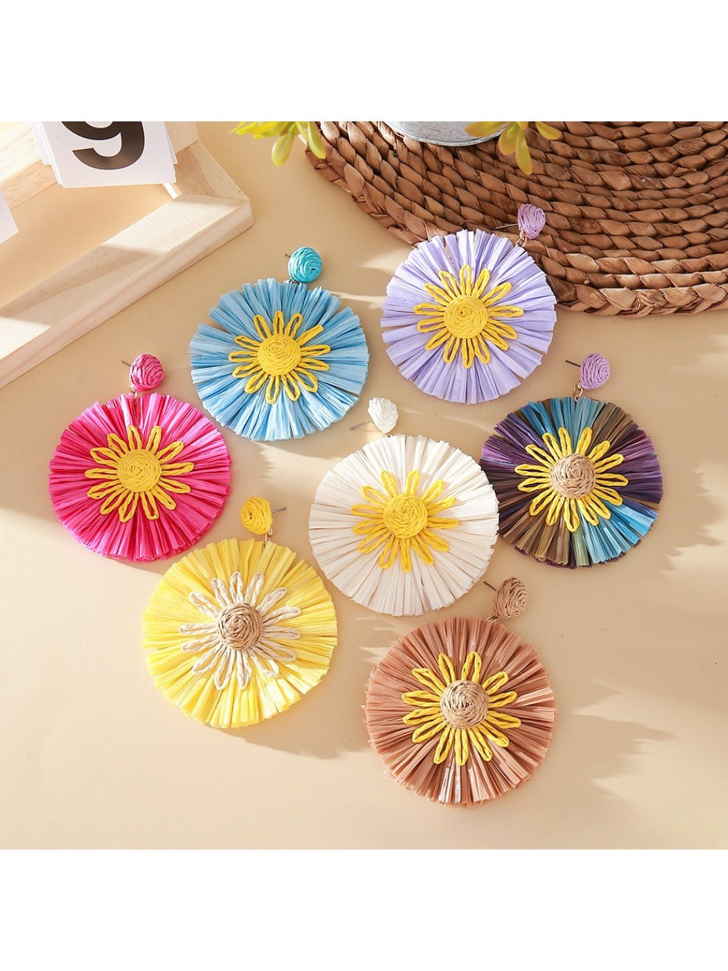 Close-up of Earedge color block sunflower shaped earrings on white background