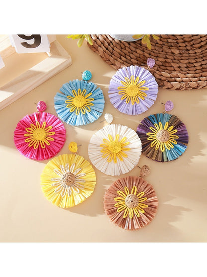 Close-up of Earedge color block sunflower shaped earrings on white background