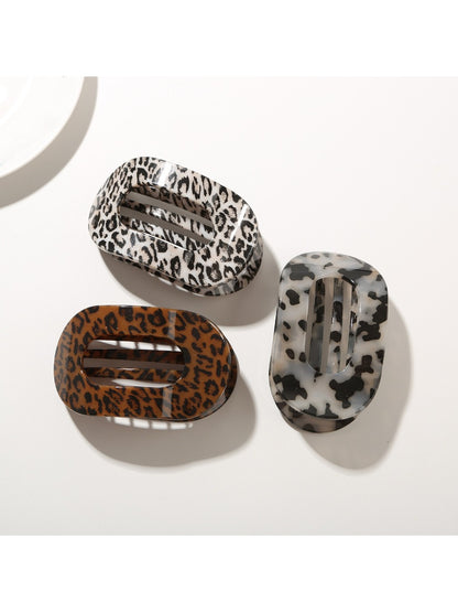 Side view of Beau patterned hair clip highlighting curved shape and clasp mechanism
