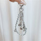 Close-up of textured golf ball charm attached to silver keyring