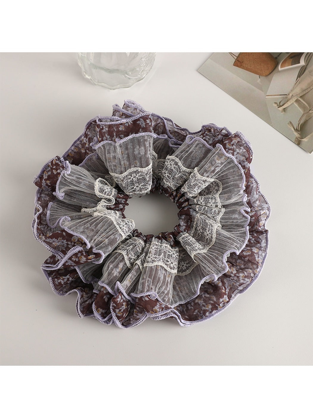 Vintage purple floral scrunchie styled with casual outfit on a wooden surface