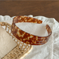 Gifty headband angled to show inner side and acetate material