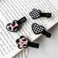 Close-up of Beau flower and heart acrylic hair clip showing detailed pink flower