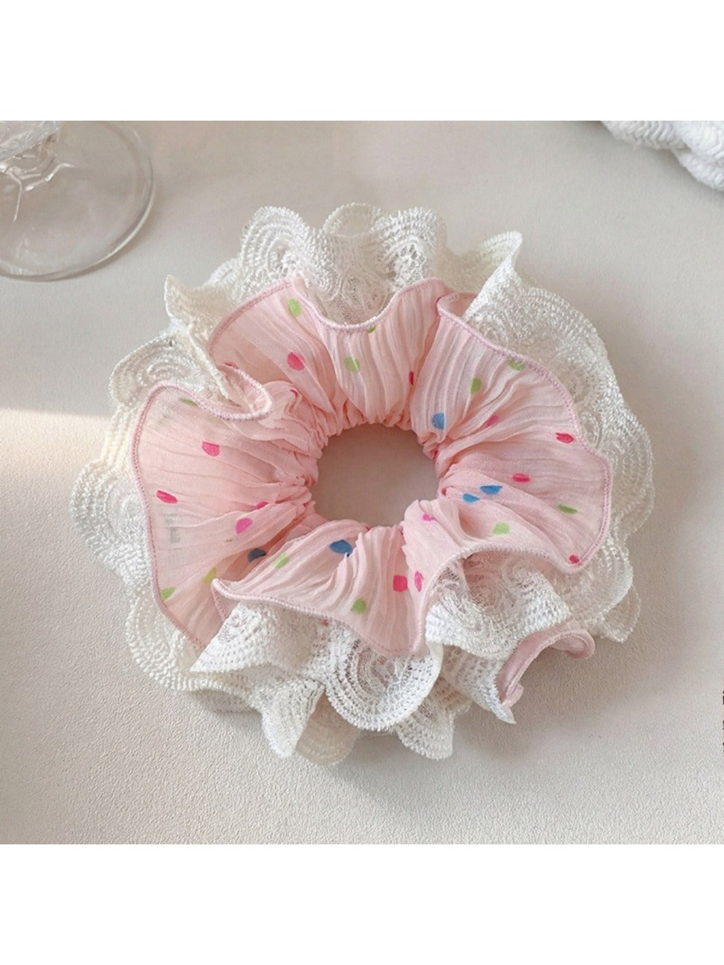 Gifty scrunchie laid flat showing polka dot pattern and lace trim