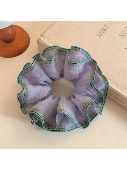 Purple double layer ruffled scrunchie displayed flat showing layers