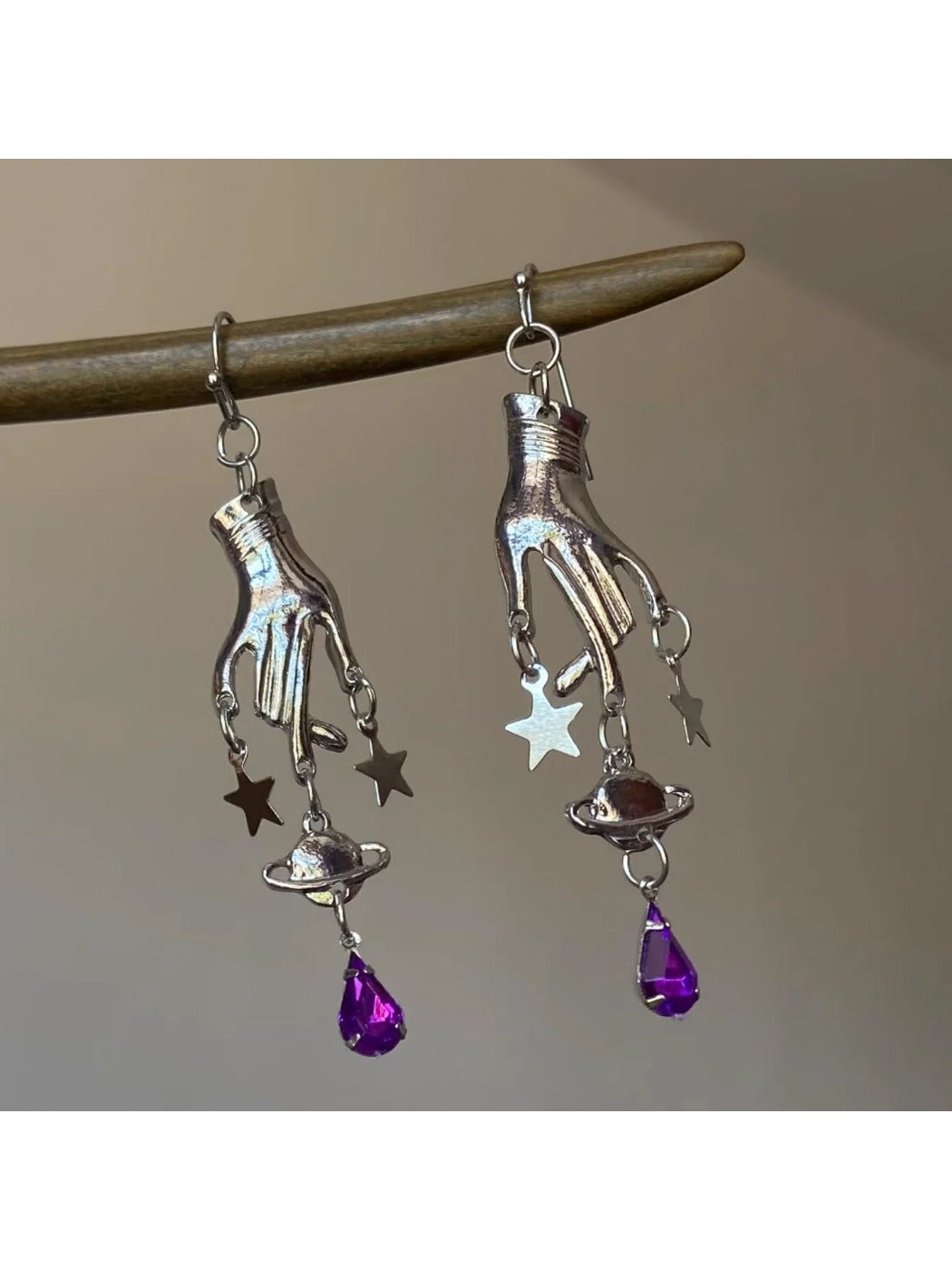 Model wearing Earedge Magic Hand Pendant Earrings with a casual outfit