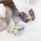 Close-up of Beau double layer hollow bow shaped claw clip showing clip mechanism