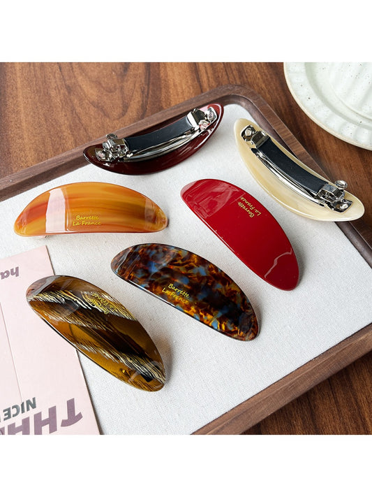 Beau acetate oval ponytail hair clip in tortoiseshell pattern on white background