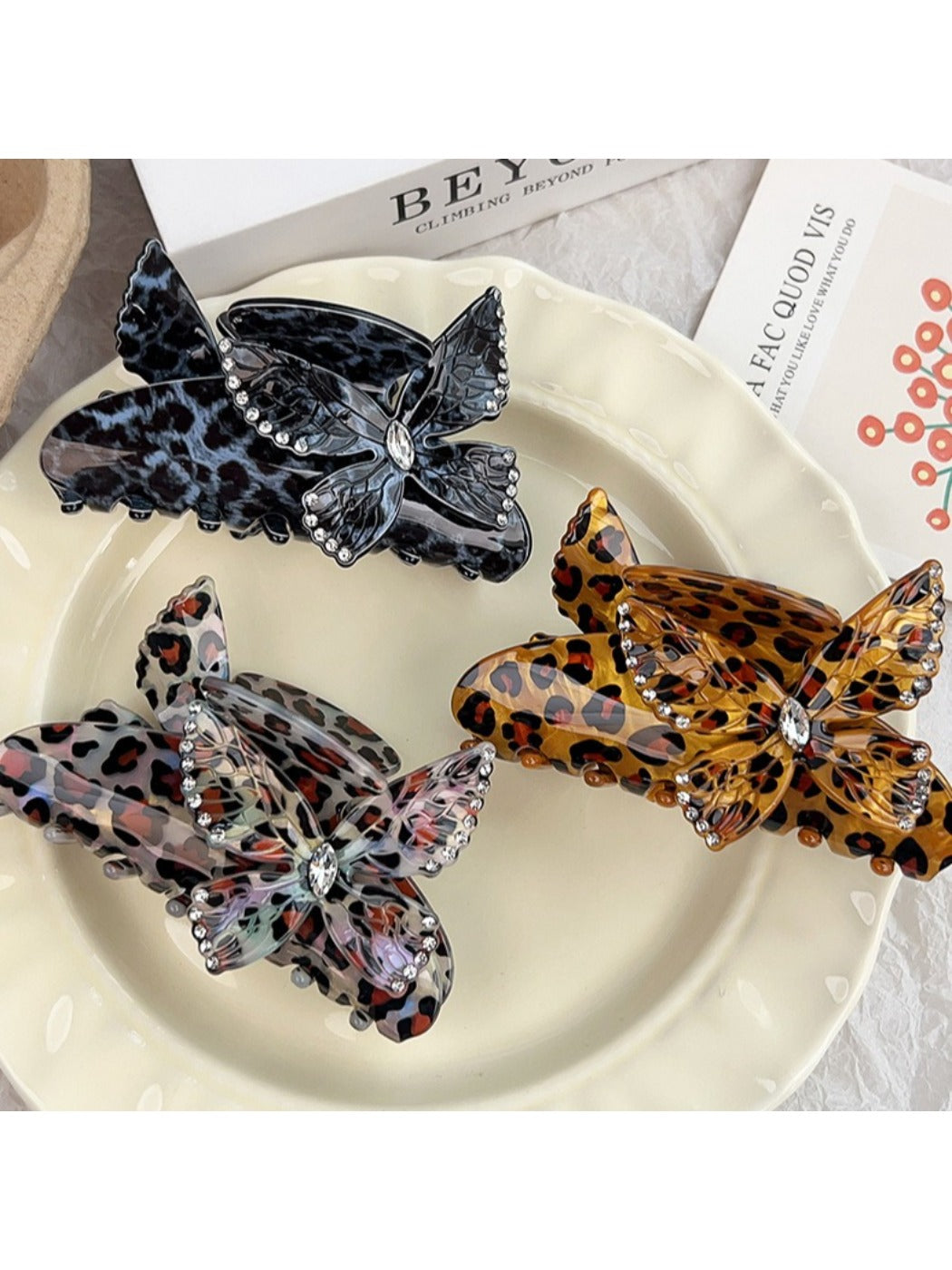 Top view of Beau leopard print claw clip highlighting butterfly embellishment