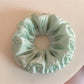 Sweet green double layered scrunchie with soft fabric texture
