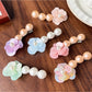 Beau Camellia shaped hair clip with white beads on a light background