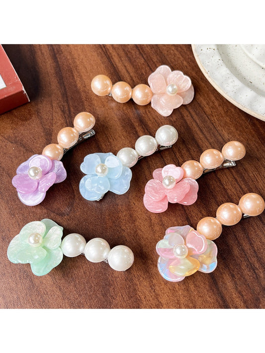 Beau Camellia shaped hair clip with white beads on a light background