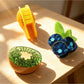 Beau fruit shaped claw clip in yellow, resembling a banana with curved design