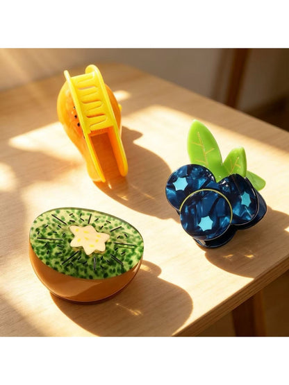 Beau fruit shaped claw clip in yellow, resembling a banana with curved design