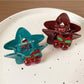 Beau star shaped hair claw clip displayed on a wooden surface