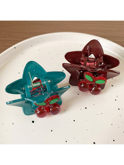 Beau star shaped hair claw clip displayed on a wooden surface